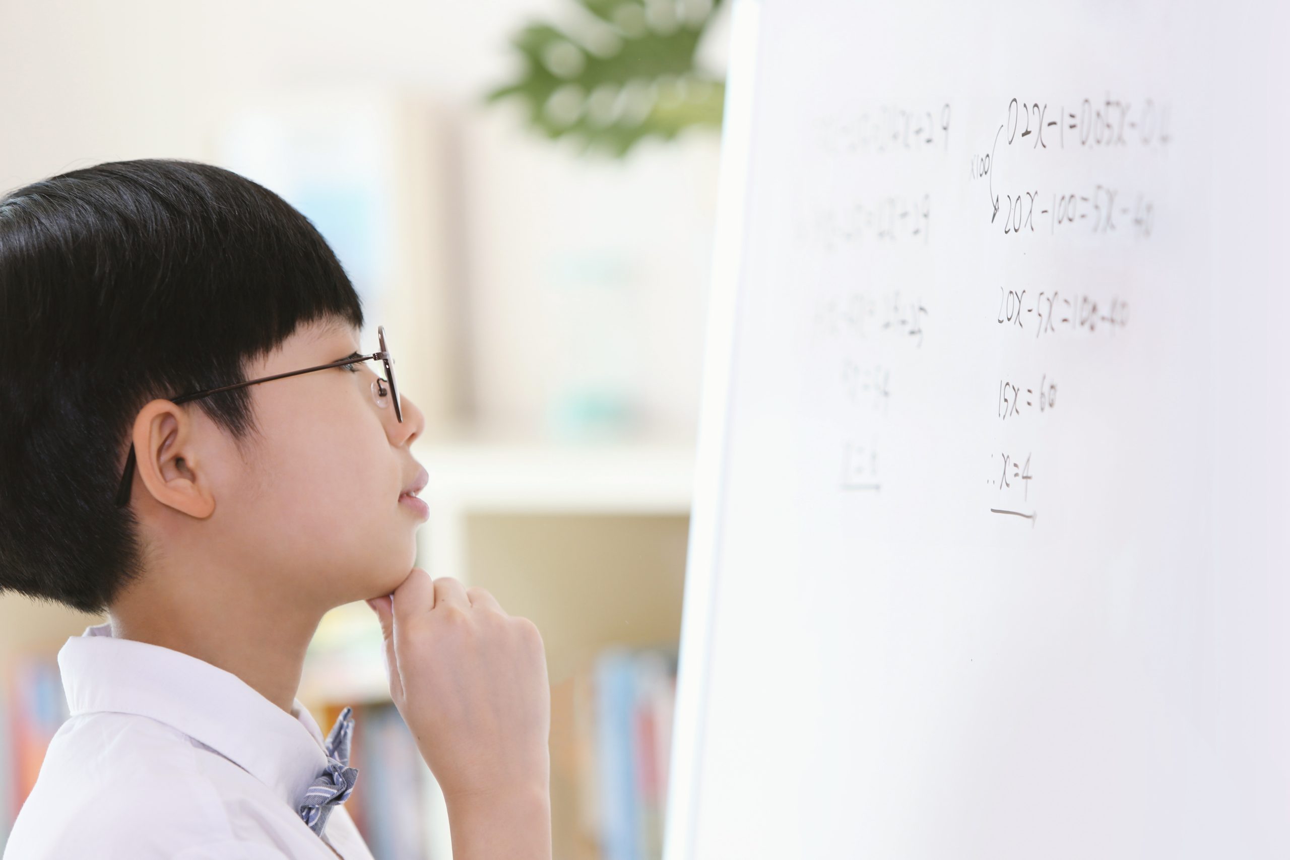 smart cute boy concentrating his studies by thinking carefully contemplating hard while s (1) smart cute boy concentrating his studies by thinking carefully contemplating hard while s (1)